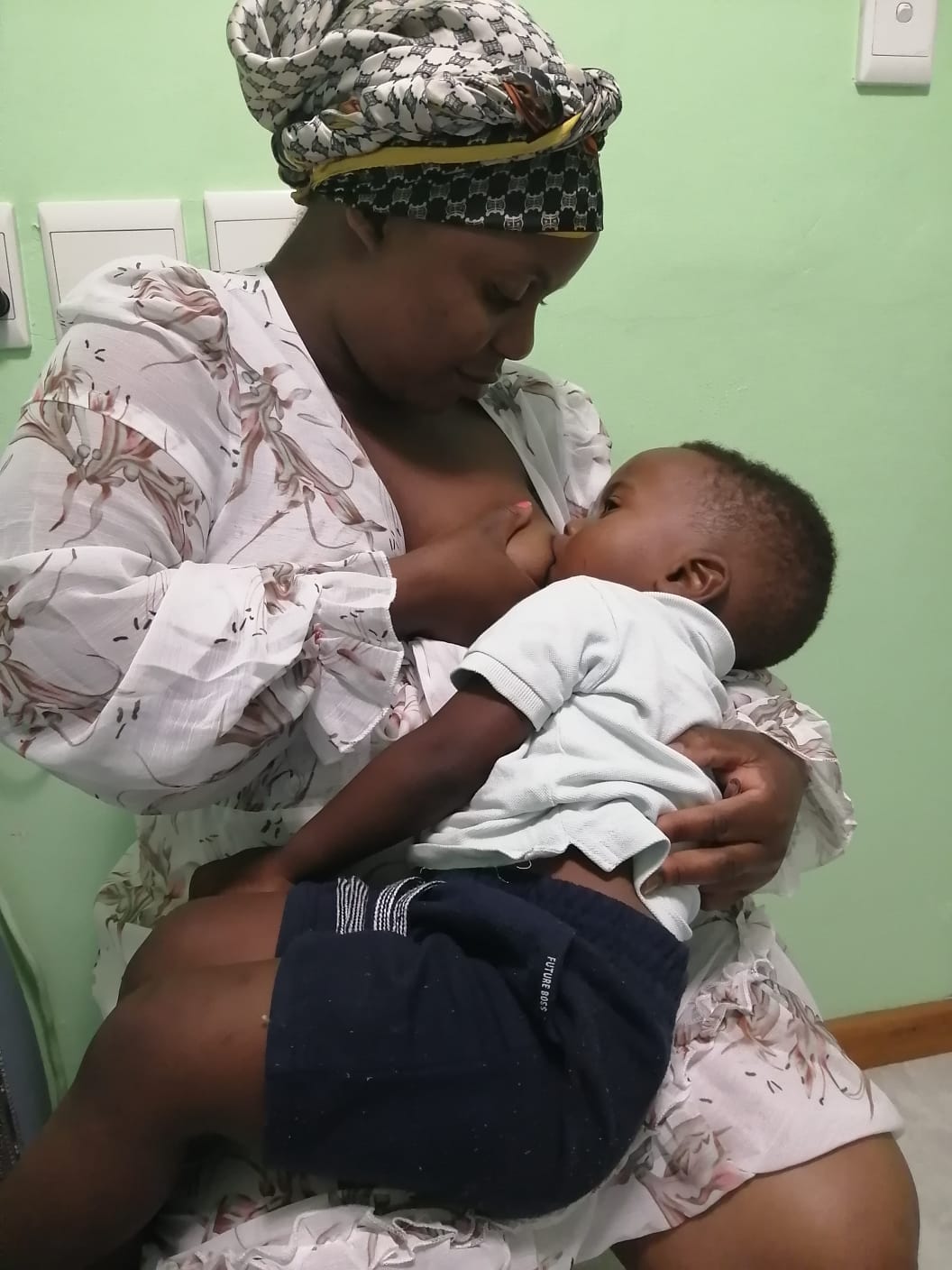 Mother breastfeeding her baby in hospital setting